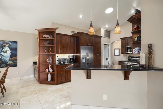 3394 N 147th Ln, Goodyear, AZ 85395 - kitchen with open shelves, appliances with stainless steel finishes, backsplash, and a peninsula