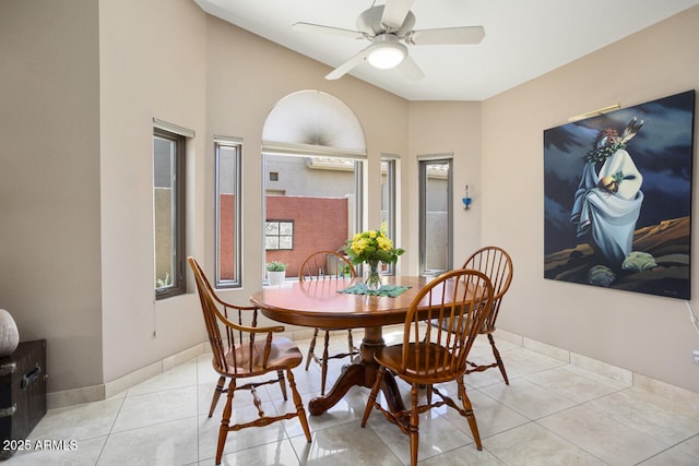 3394 N 147th Ln, Goodyear, AZ 85395 - dining space with a ceiling fan, light tile patterned floors, baseboards, and lofted ceiling