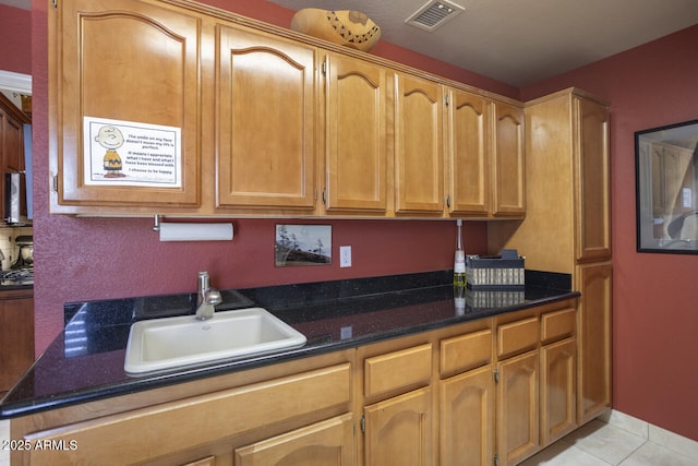 3394 N 147th Ln, Goodyear, AZ 85395 - kitchen with a sink, light tile patterned floors, and dark stone countertops