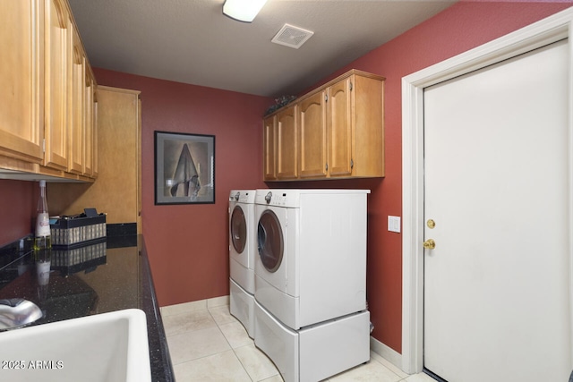 3394 N 147th Ln, Goodyear, AZ 85395 - clothes washing area with washer and dryer, baseboards, light tile patterned flooring, and cabinet space