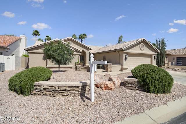 3394 N 147th Ln, Goodyear, AZ 85395 - ranch-style house featuring a tiled roof, a garage, central AC unit, stucco siding, and fence