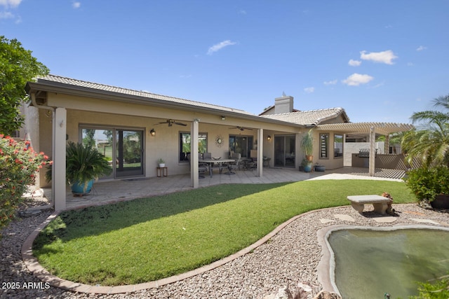 3394 N 147th Ln, Goodyear, AZ 85395 - back of house featuring ceiling fan, a pergola, a yard, stucco siding, and a chimney