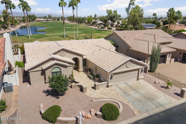 3394 N 147th Ln, Goodyear, AZ 85395 - view of front facade featuring an attached garage, stucco siding, a water view, central AC unit, and concrete driveway