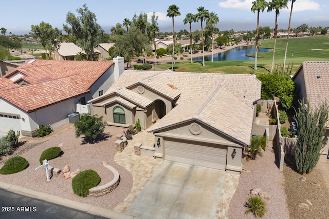 3394 N 147th Ln, Goodyear, AZ 85395 - view of front of house with a water view, view of golf course, stucco siding, a garage, and driveway
