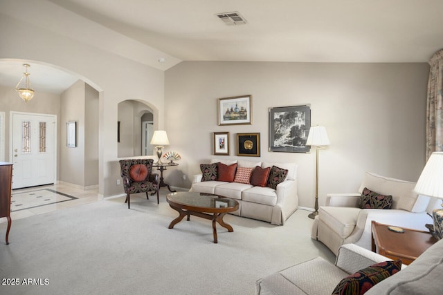 3394 N 147th Ln, Goodyear, AZ 85395 - carpeted living area with arched walkways, vaulted ceiling, and baseboards