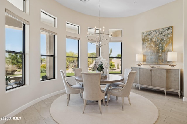 6450 E Monterra Way, Scottsdale, AZ 85266 - dining area featuring a chandelier, plenty of natural light, light tile patterned flooring, and a towering ceiling