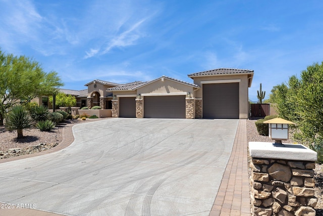6450 E Monterra Way, Scottsdale, AZ 85266 - mediterranean / spanish home featuring an attached garage, stucco siding, driveway, stone siding, and a tile roof