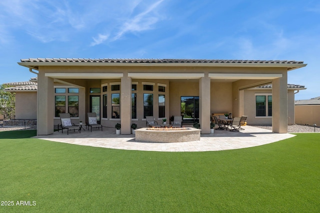 6450 E Monterra Way, Scottsdale, AZ 85266 - back of house with an outdoor fire pit, a patio area, stucco siding, and a yard