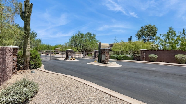 6450 E Monterra Way, Scottsdale, AZ 85266 - view of asphalt road with a gate, a gated entry, and curbs