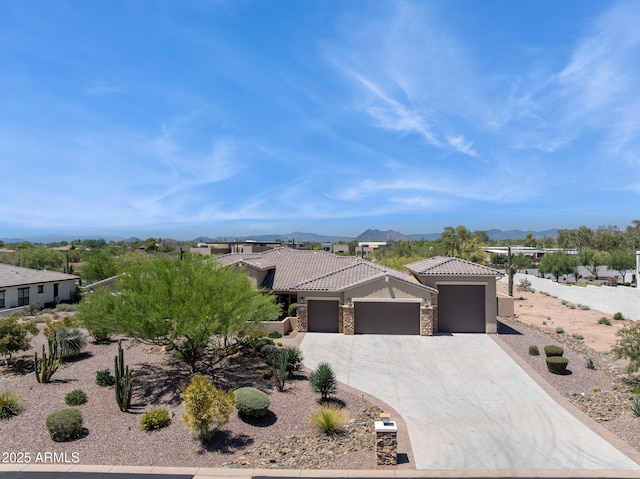 6450 E Monterra Way, Scottsdale, AZ 85266 - view of front of property with a garage, a tile roof, a mountain view, stone siding, and driveway