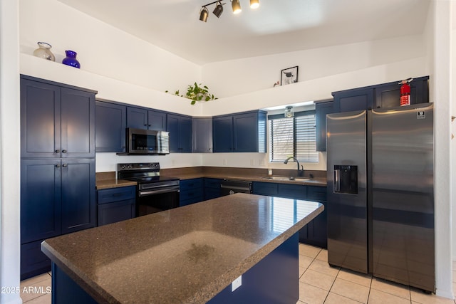 kitchen with light tile patterned floors, a center island, a sink, black appliances, and blue cabinets