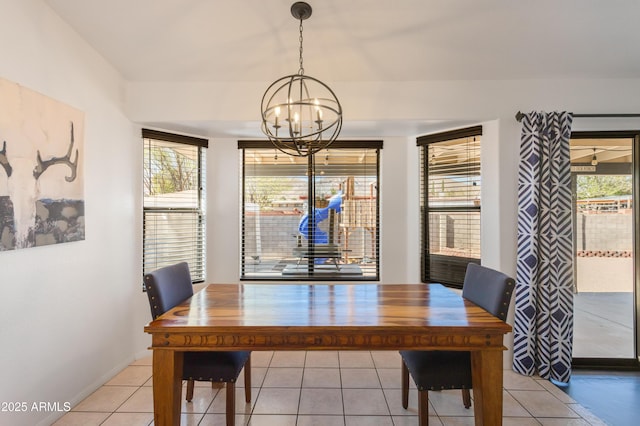 dining space featuring light tile patterned flooring, an inviting chandelier, baseboards, and a wealth of natural light