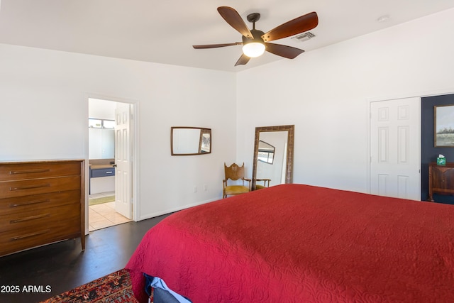 bedroom featuring finished concrete flooring, ensuite bathroom, a ceiling fan, and visible vents