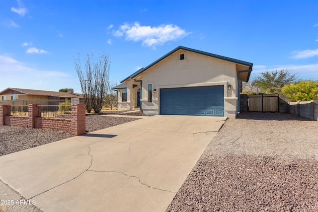view of home's exterior featuring a garage, stucco siding, fence, a gate, and driveway