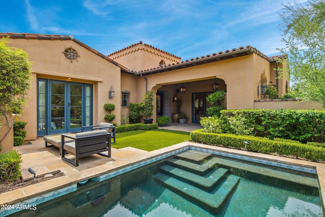 rear view of house featuring a patio area, a tile roof, an outdoor living space, and stucco siding