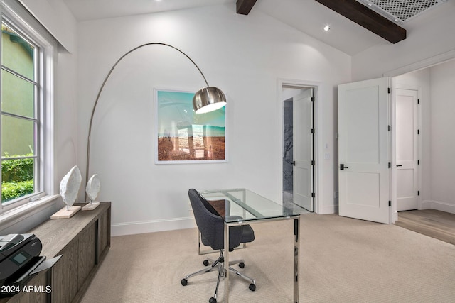 home office featuring lofted ceiling with beams, baseboards, visible vents, and light colored carpet