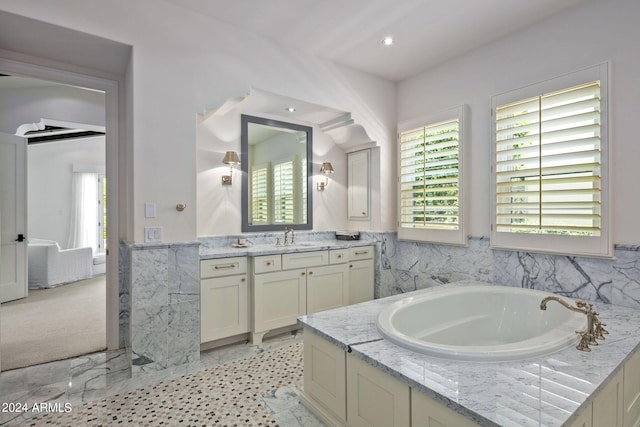 full bath featuring a garden tub, vanity, and recessed lighting