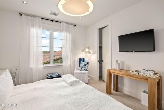 bedroom featuring light carpet, baseboards, and visible vents