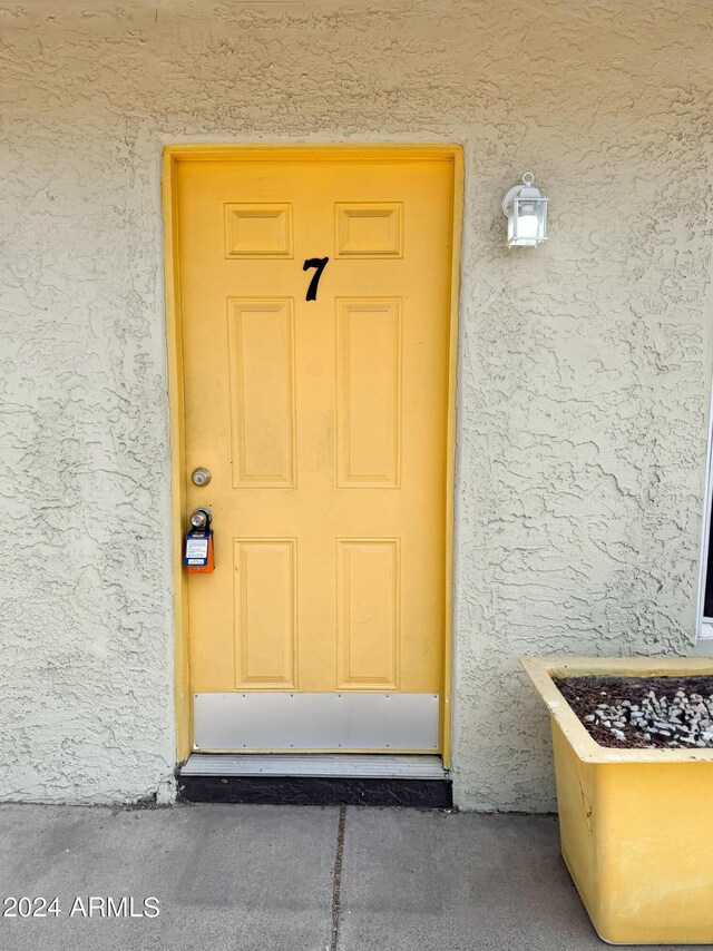 view of exterior entry with stucco siding