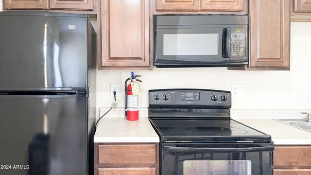 kitchen with light countertops and black appliances