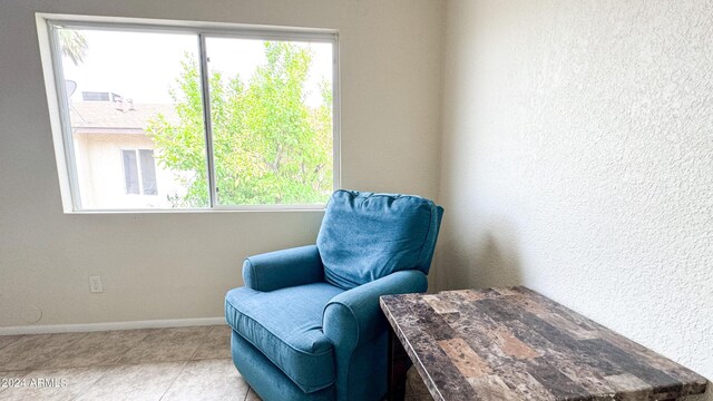 living area with tile patterned flooring and baseboards