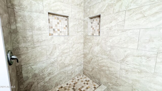 bathroom with tiled shower