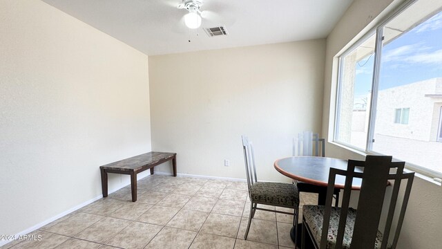 dining space with visible vents, ceiling fan, baseboards, and light tile patterned floors