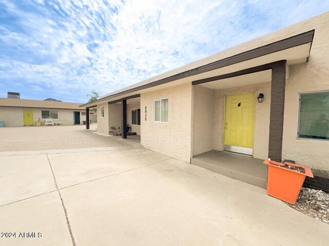 view of front facade with a patio area and stucco siding