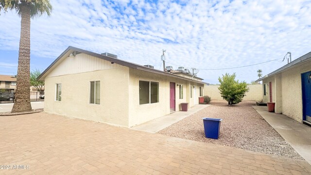 view of home's exterior featuring a patio, fence, and stucco siding