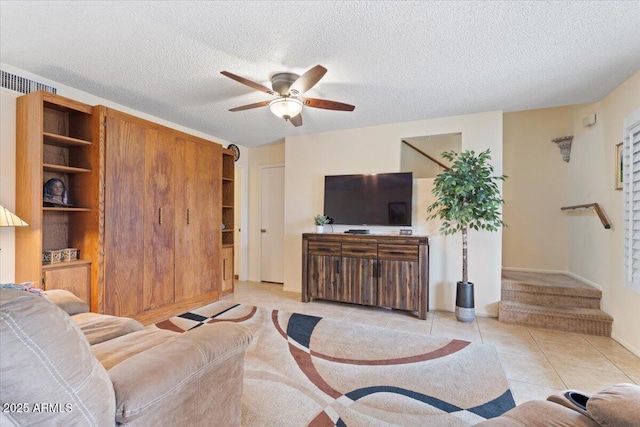 16510 E Palisades Blvd Unit 42, Fountain Hills, AZ 85268 - living room with a ceiling fan, light tile patterned floors, stairway, a textured ceiling, and baseboards
