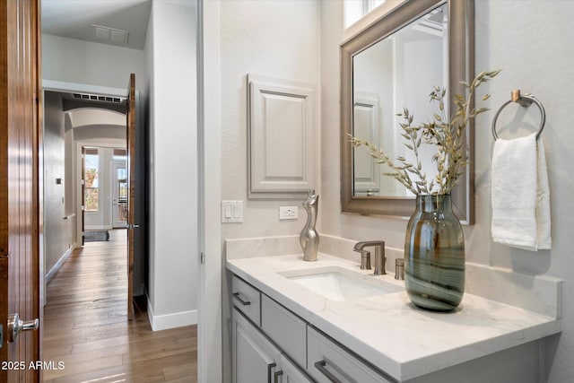 34599 N 99th Way, Scottsdale, AZ 85262 - bathroom featuring vanity, wood finished floors, and baseboards