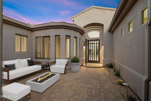 34599 N 99th Way, Scottsdale, AZ 85262 - patio terrace at dusk with a patio area and an outdoor living space with a fire pit