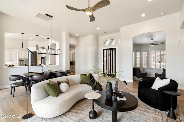 34599 N 99th Way, Scottsdale, AZ 85262 - living area featuring a ceiling fan, arched walkways, light wood-style floors, recessed lighting, and baseboards