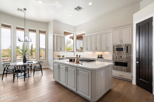 34599 N 99th Way, Scottsdale, AZ 85262 - kitchen featuring appliances with stainless steel finishes, a kitchen island, light countertops, a chandelier, and recessed lighting