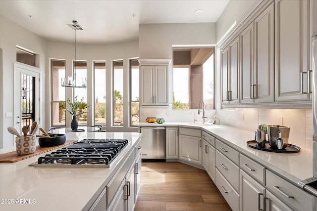 34599 N 99th Way, Scottsdale, AZ 85262 - kitchen with stainless steel appliances, a chandelier, light countertops, and decorative light fixtures