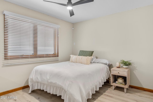 bedroom featuring ceiling fan, wood finished floors, and baseboards