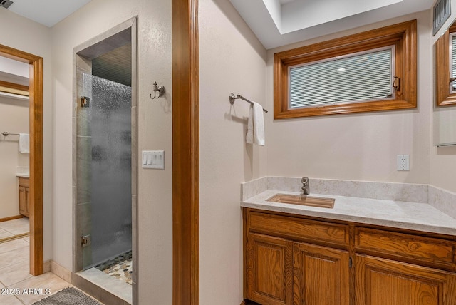 full bath featuring a stall shower, tile patterned floors, visible vents, and vanity