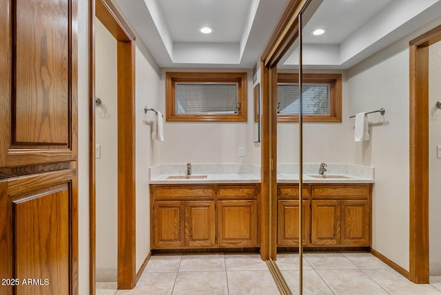 bathroom featuring double vanity, a sink, and tile patterned floors