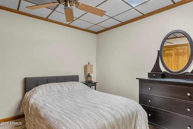 bedroom featuring ornamental molding and a ceiling fan