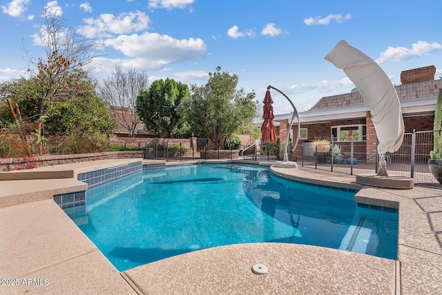 view of pool with a fenced in pool, a patio area, and fence