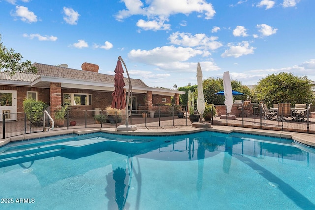 view of pool with fence, a fenced in pool, and a patio