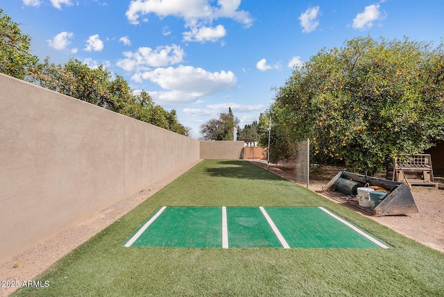 view of car parking with a fenced backyard