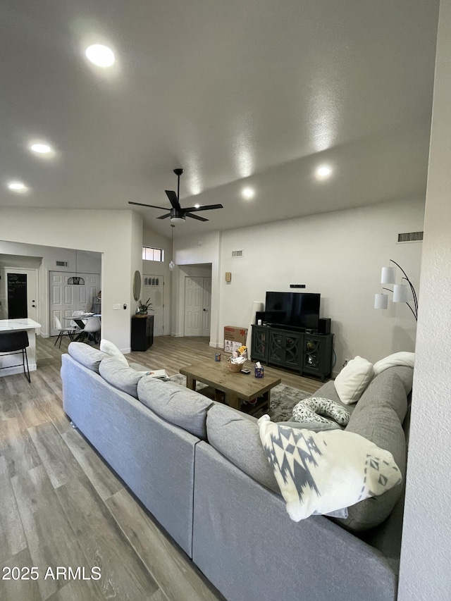 living room featuring ceiling fan and wood-type flooring