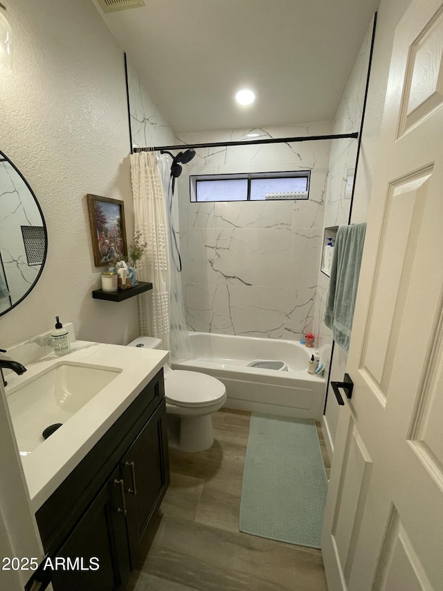 full bathroom with shower / bath combo with shower curtain, vanity, and toilet