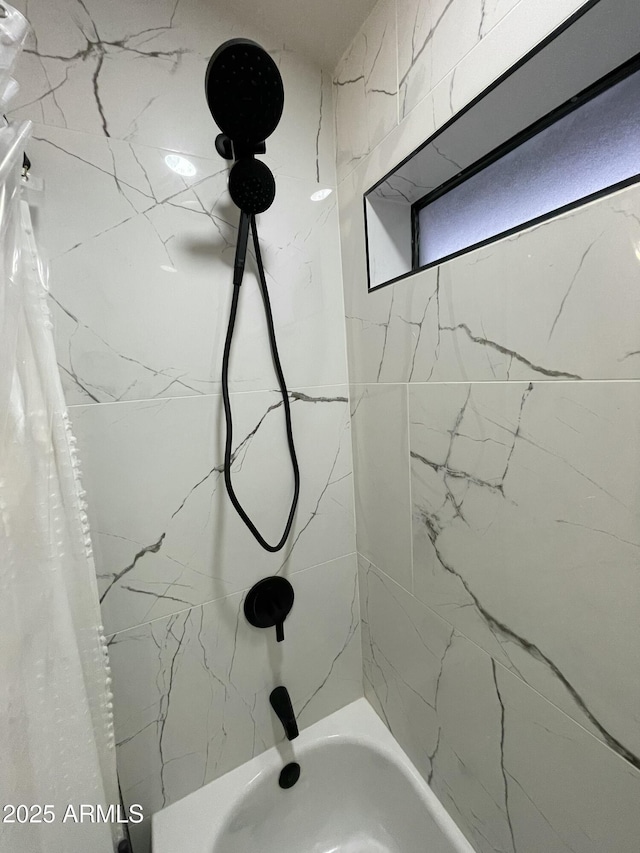 bathroom with shower / bath combo with shower curtain