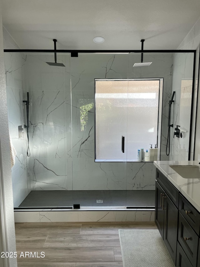 bathroom featuring vanity and a shower with shower door