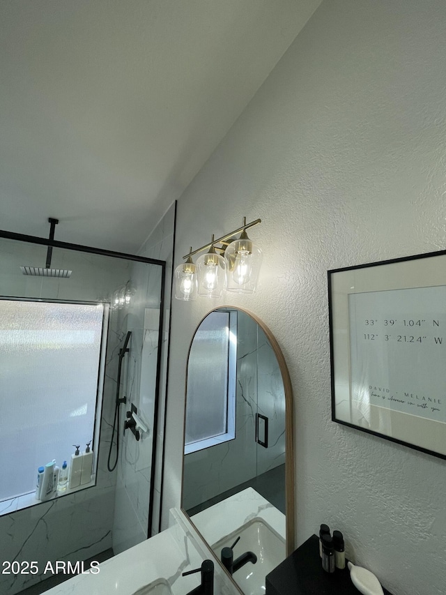 bathroom featuring a healthy amount of sunlight and a shower with shower door