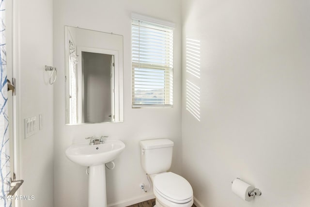 bathroom with plenty of natural light and toilet