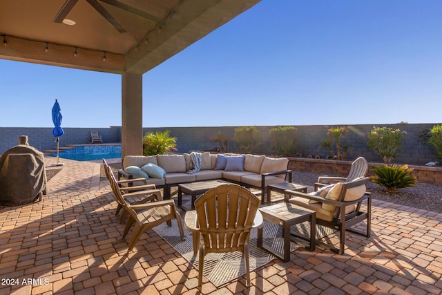 view of patio with a fenced in pool, ceiling fan, and an outdoor hangout area