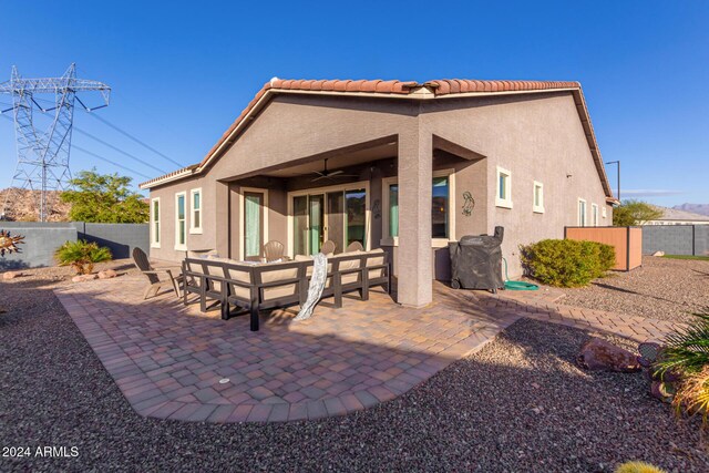 back of house with ceiling fan and a patio area